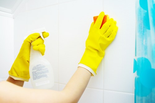 Local cleaner assessing curtains in a Battersea property
